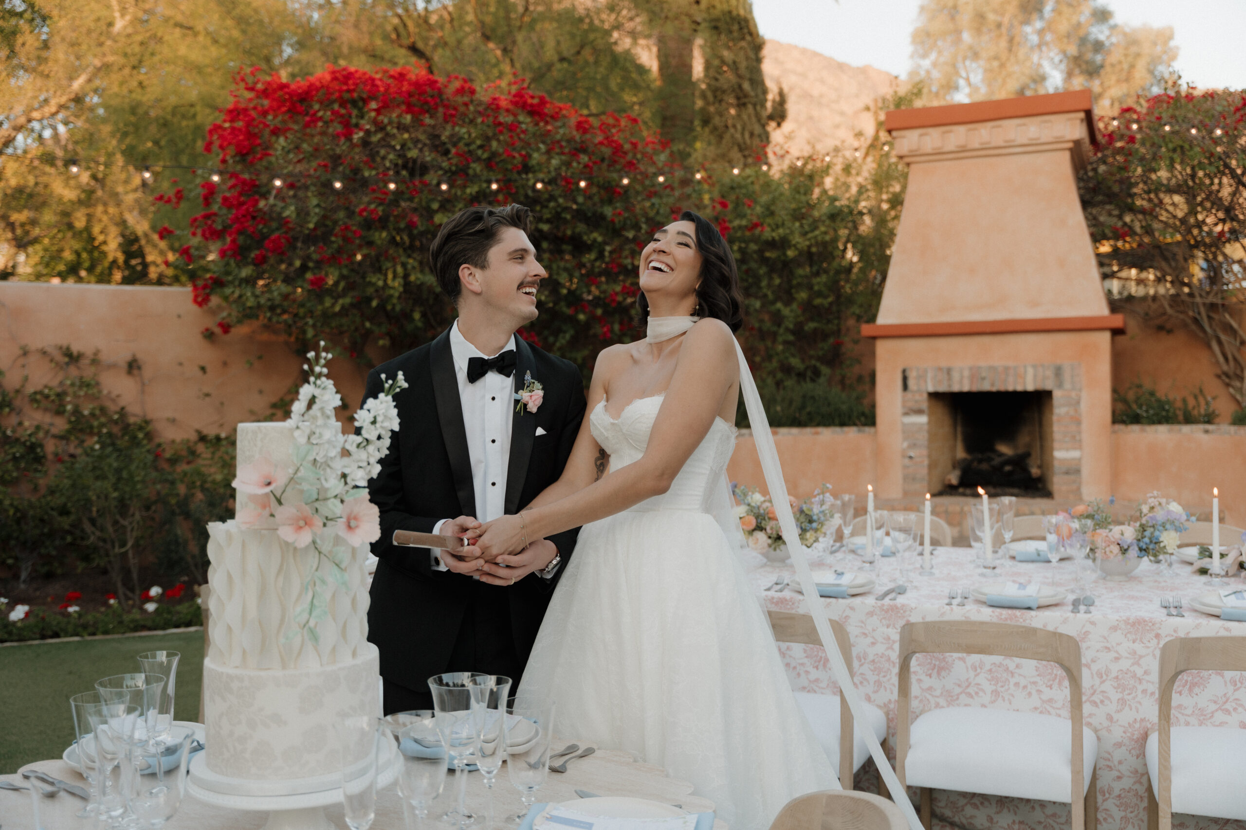 Bride and Groom cutting their cake in the Alegria Garden at the Royal Palms