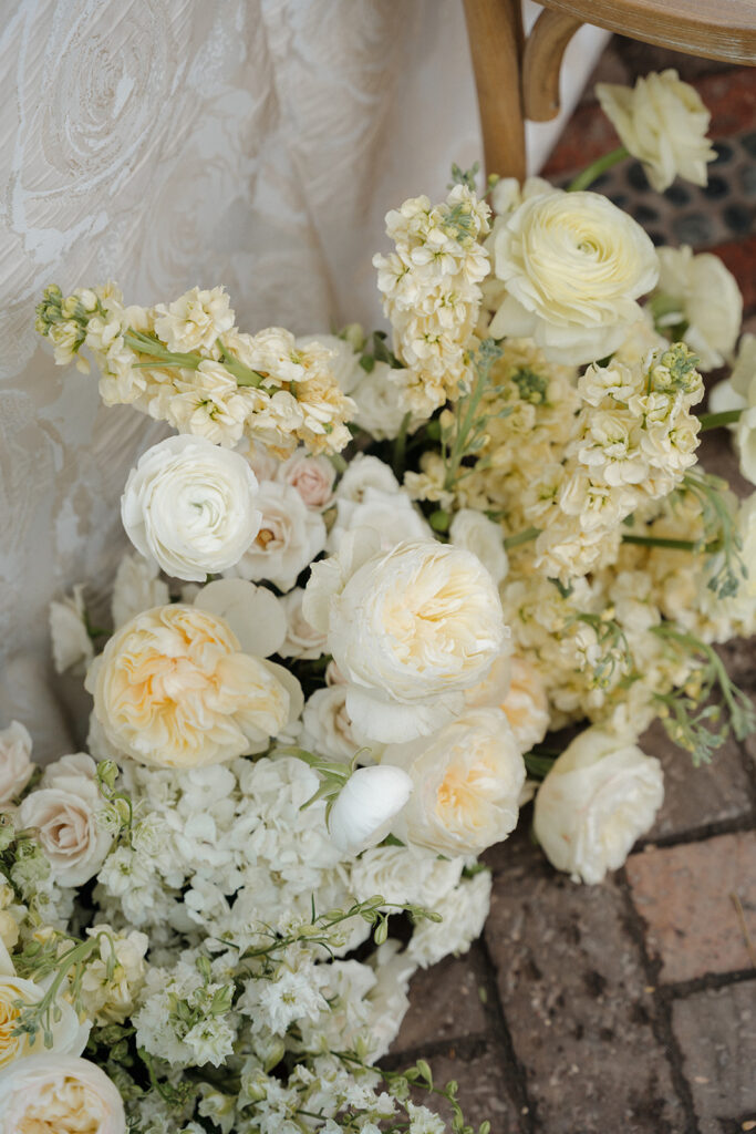 Lush floral arrangements bringing seasonal charm to a butter yellow wedding ceremony.