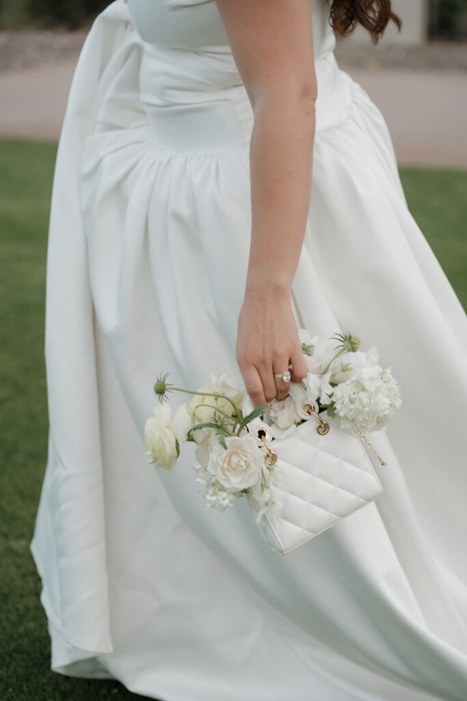 A playful bouquet tucked into the bride’s bag at this whimsical butter yellow wedding.